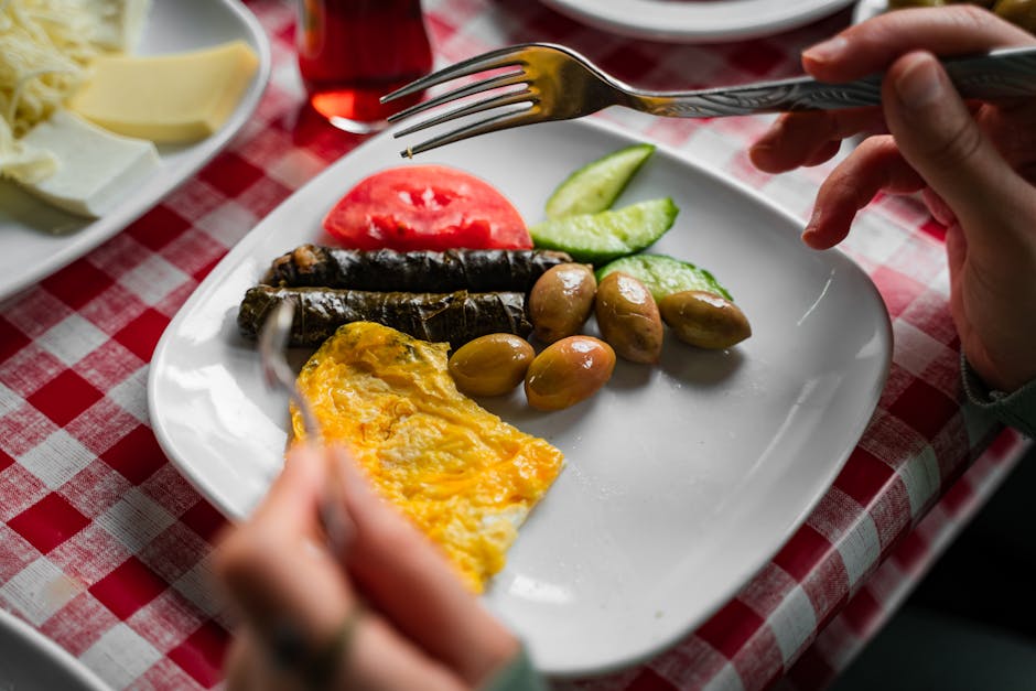 A vibrant plate of traditional Turkish breakfast with olives, omelette, and fresh vegetables in Bursa.